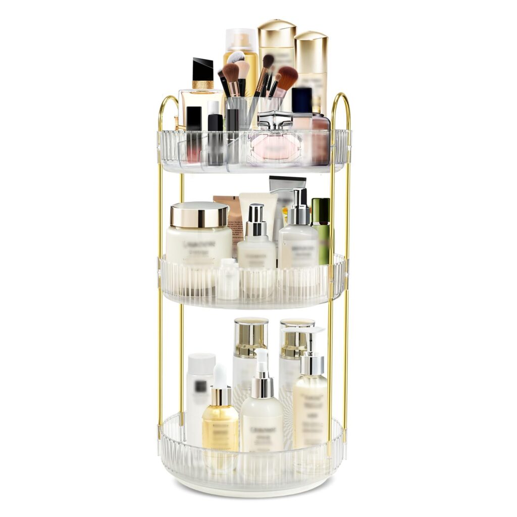 3-tier rotating makeup organizer with gold-tone frame and clear plastic trays on a vanity countertop