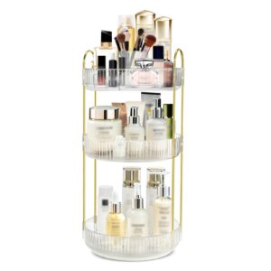 3-tier rotating makeup organizer with gold-tone frame and clear plastic trays on a vanity countertop
